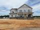 Two-story home with stone accents and large windows on a large lot at 111 Demascus Way # 021, Four Oaks, NC 27524