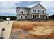 Two-story home with stone accents and large windows on a large lot at 111 Demascus Way # 021, Four Oaks, NC 27524