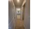Hallway view leading to a bathroom and closet, with neutral carpeting at 111 Demascus Way # 021, Four Oaks, NC 27524