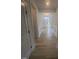Inviting hallway with wood flooring and detailed trim, leading to a bright entrance at 111 Demascus Way # 021, Four Oaks, NC 27524