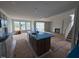 Open-concept kitchen with island, stairs, and fireplace and natural light at 111 Demascus Way # 021, Four Oaks, NC 27524