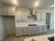 Modern kitchen boasting white cabinets, stainless steel appliances, and granite countertops at 111 Demascus Way # 021, Four Oaks, NC 27524