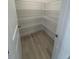 Walk-in pantry featuring wire shelving and light hardwood floors at 111 Demascus Way # 021, Four Oaks, NC 27524