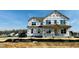Two story new construction home with visible house wrap and window openings at 111 Demascus Way # 021, Four Oaks, NC 27524