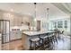 Modern kitchen featuring stainless steel appliances, a kitchen island with seating, and gray cabinetry at 111 Demascus Way # 021, Four Oaks, NC 27524