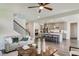 Inviting living room with hardwood floors, a comfortable couch, and an open view to the kitchen and staircase at 111 Demascus Way # 021, Four Oaks, NC 27524