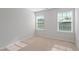 Light-filled bedroom features neutral carpet and paint, and a bright window with blinds at 9216 Leaning Post Rd # 447, Wake Forest, NC 27587