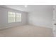 Bright, carpeted bedroom featuring a window and white trim at 9216 Leaning Post Rd # 447, Wake Forest, NC 27587