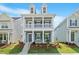 Charming two-story home featuring a double front porch, grey siding, and meticulously landscaped front yard at 9216 Leaning Post Rd # 447, Wake Forest, NC 27587