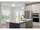 Modern kitchen featuring an island with a sink, stainless steel appliances, and white cabinets at 9216 Leaning Post Rd # 447, Wake Forest, NC 27587