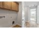 Laundry area with overhead storage and connections for a washer and dryer at 9216 Leaning Post Rd # 447, Wake Forest, NC 27587