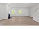 Bright living room with a fireplace, hardwood floors, and large windows providing ample natural light at 9216 Leaning Post Rd # 447, Wake Forest, NC 27587
