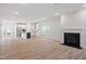 Open-concept living space featuring a modern kitchen, fireplace, and hardwood floors at 9216 Leaning Post Rd # 447, Wake Forest, NC 27587