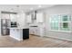 Bright, open kitchen with white cabinets, stainless steel appliances, and a large island at 9216 Leaning Post Rd # 447, Wake Forest, NC 27587