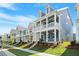 Street view of newly constructed homes, each with inviting front porches and well-maintained landscaping at 9216 Leaning Post Rd # 447, Wake Forest, NC 27587
