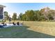 Vast backyard with patio seating area and lush greenery, perfect for outdoor gatherings at 120 W Weatherford Dr, Angier, NC 27501