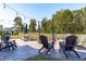 Spacious backyard with patio, string lights, outdoor seating area, and expansive lawn at 120 W Weatherford Dr, Angier, NC 27501