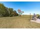 Sprawling backyard featuring a patio with outdoor seating, an umbrella, and a view of the open field at 120 W Weatherford Dr, Angier, NC 27501