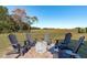 Backyard featuring a fire pit area with Adirondack chairs on a stamped concrete patio at 120 W Weatherford Dr, Angier, NC 27501