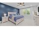 Elegant bedroom with a blue accent wall, white furniture, and plush bedding at 120 W Weatherford Dr, Angier, NC 27501