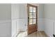 View of entryway featuring a glass panel door and wainscoting at 120 W Weatherford Dr, Angier, NC 27501
