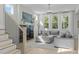 Bright living room with fireplace, large windows, and staircase at 120 W Weatherford Dr, Angier, NC 27501