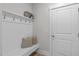 Functional mudroom featuring a built-in bench with storage, hooks, and a nearby door at 120 W Weatherford Dr, Angier, NC 27501