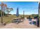 Outdoor patio with string lights, picnic table, umbrella, and views of the expansive backyard at 120 W Weatherford Dr, Angier, NC 27501