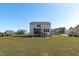 Rear view of a house with a screened porch, a patio, and an expansive yard at 120 W Weatherford Dr, Angier, NC 27501