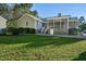 Ranch-style home with a screened porch and grassy yard at 1604 Burnt Mill Rd, Rocky Mount, NC 27804