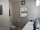 Clean bathroom with vanity, toilet, and window at 3016 Old Craig Trail, Mebane, NC 27302