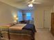 Spacious bedroom with striped bedding and a workspace at 3016 Old Craig Trail, Mebane, NC 27302