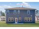 Backyard exterior showcasing modern siding, a well-manicured lawn, and new home construction at 114 Hickory Grove Dr, Sanford, NC 27330