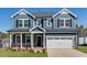 Charming two-story home with a two-car garage, blue siding, and stone accents at 114 Hickory Grove Dr, Sanford, NC 27330