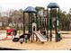 Community playground featuring slides, climbing structures, and shaded areas for enjoyment at 114 Hickory Grove Dr, Sanford, NC 27330