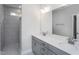 Bathroom boasts double sinks, gray cabinets, quartz counters, walk-in shower and tile floors at 1230 Linkwood, Homesite 44, Fuquay Varina, NC 27526