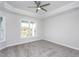 Bedroom features a tray ceiling, ceiling fan, carpet, and large windows with a lake view at 1230 Linkwood, Homesite 44, Fuquay Varina, NC 27526