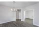Dining room with modern chandelier, wood floors, and neutral color palette at 1230 Linkwood, Homesite 44, Fuquay Varina, NC 27526