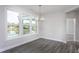 Bright dining room with modern chandelier, wood floors and large windows with pond view at 1230 Linkwood, Homesite 44, Fuquay Varina, NC 27526