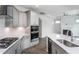 This modern kitchen features a central island, gray cabinetry, stainless appliances, and views to the living room at 1230 Linkwood, Homesite 44, Fuquay Varina, NC 27526