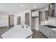 An open kitchen features a spacious island, gray cabinetry, stainless appliances, and views to the dining room at 1230 Linkwood, Homesite 44, Fuquay Varina, NC 27526