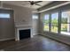 Living room features fireplace, wood floors, tray ceiling, and large windows at 1230 Linkwood, Homesite 44, Fuquay Varina, NC 27526