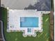 Aerial view of a backyard showcasing a modern pool and spa with clean lines, set in a well-manicured lawn at 662 Manchester Dr, Raleigh, NC 27609