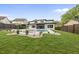 Serene backyard with a sleek modern home, featuring a pool, spa, and verdant lawn complemented by well-placed landscaping at 662 Manchester Dr, Raleigh, NC 27609
