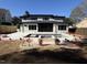 Backyard showcases a modern two-story home, swimming pool, and fire pit providing outdoor amenities at 662 Manchester Dr, Raleigh, NC 27609