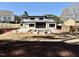 Expansive backyard featuring a modern home, a pool, and a fire pit, perfect for outdoor entertaining at 662 Manchester Dr, Raleigh, NC 27609