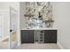 Stylish bar area with marble backsplash, wooden shelves, a wine cooler and cabinet storage at 662 Manchester Dr, Raleigh, NC 27609