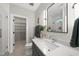 Elegant bathroom features a modern vanity, decorative mirror, and glass-enclosed shower at 662 Manchester Dr, Raleigh, NC 27609