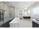 Modern bathroom with walk-in shower, soaking tub, sleek fixtures, and neutral color palette at 662 Manchester Dr, Raleigh, NC 27609