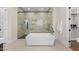 Stunning bathroom showcasing a sleek freestanding tub and spacious glass shower at 662 Manchester Dr, Raleigh, NC 27609